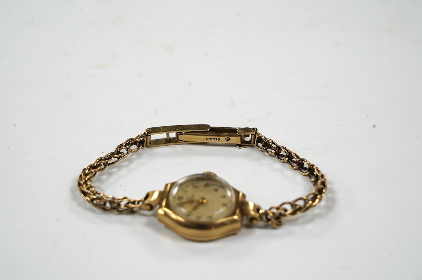 A lady's 9ct gold Omega manual wind wrist watch, on an associated 9ct bracelet, gross weight 12.8 grams. Condition - poor to fair